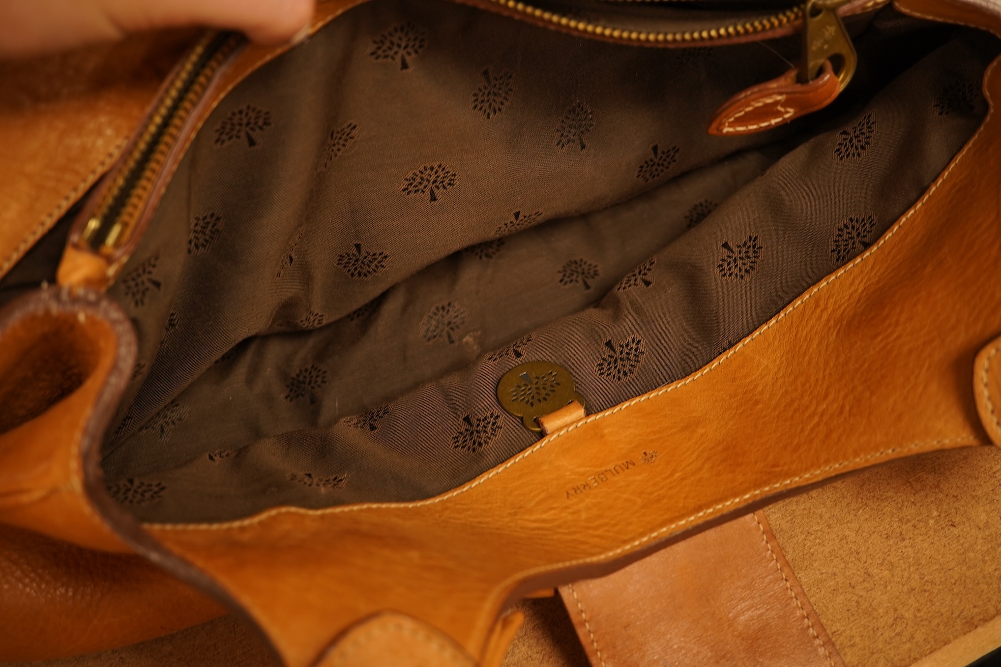 A Mulberry tote two zip, three postman clasps,tan leather with dark brown trim.handbag